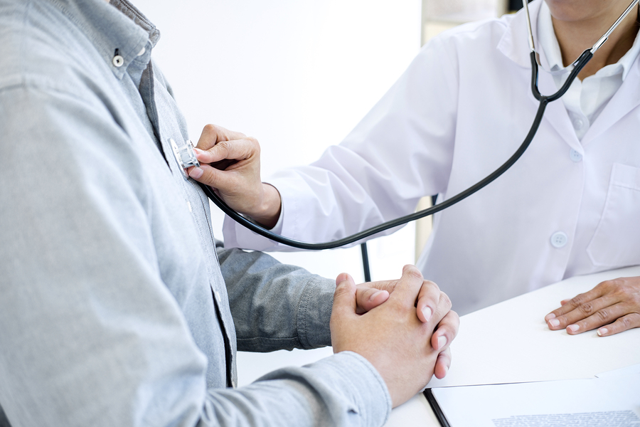 Female Doctor Checking Heart Beat Of Patient And Recommend Treat