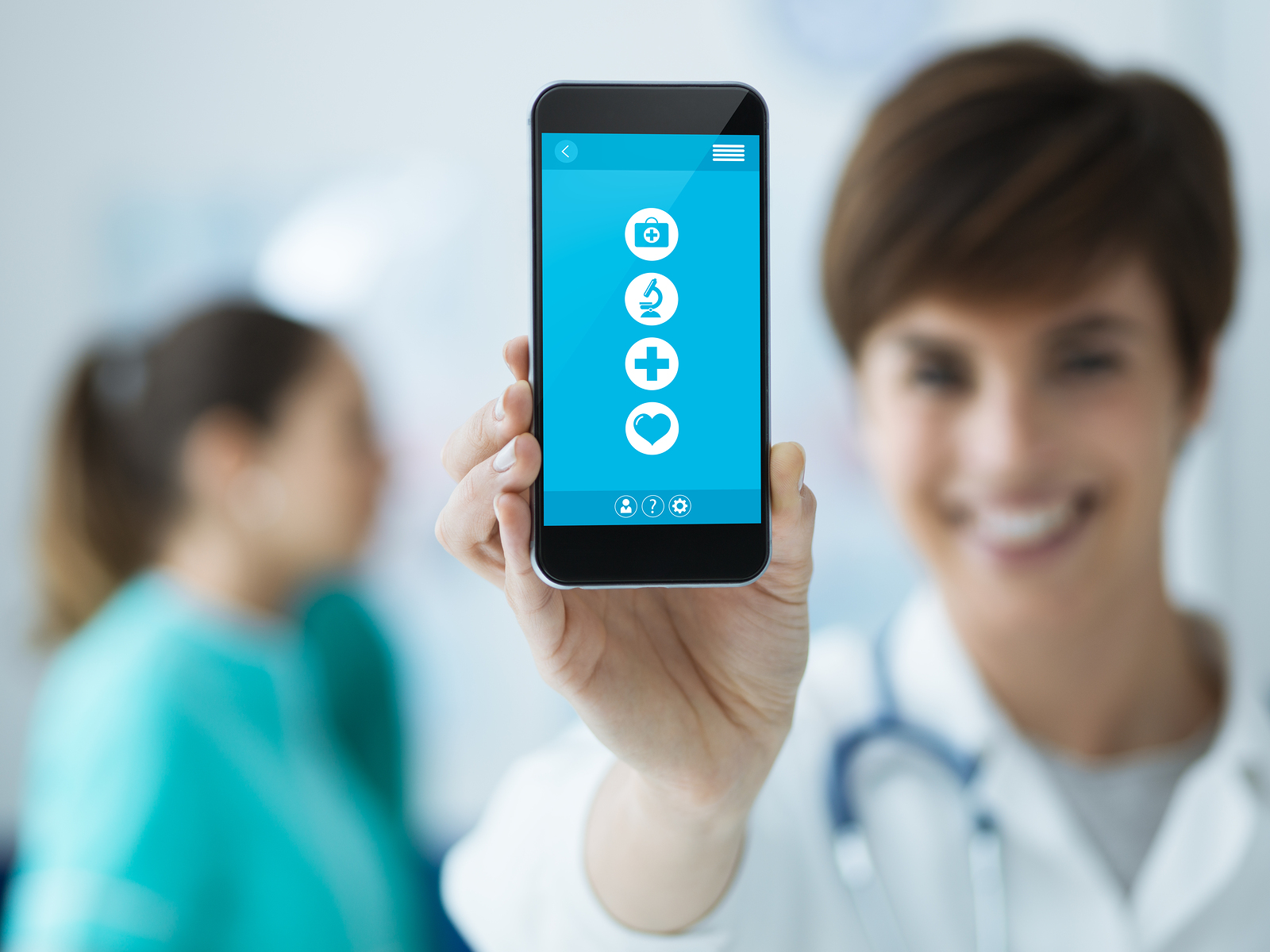 female nurse holding a smartphone