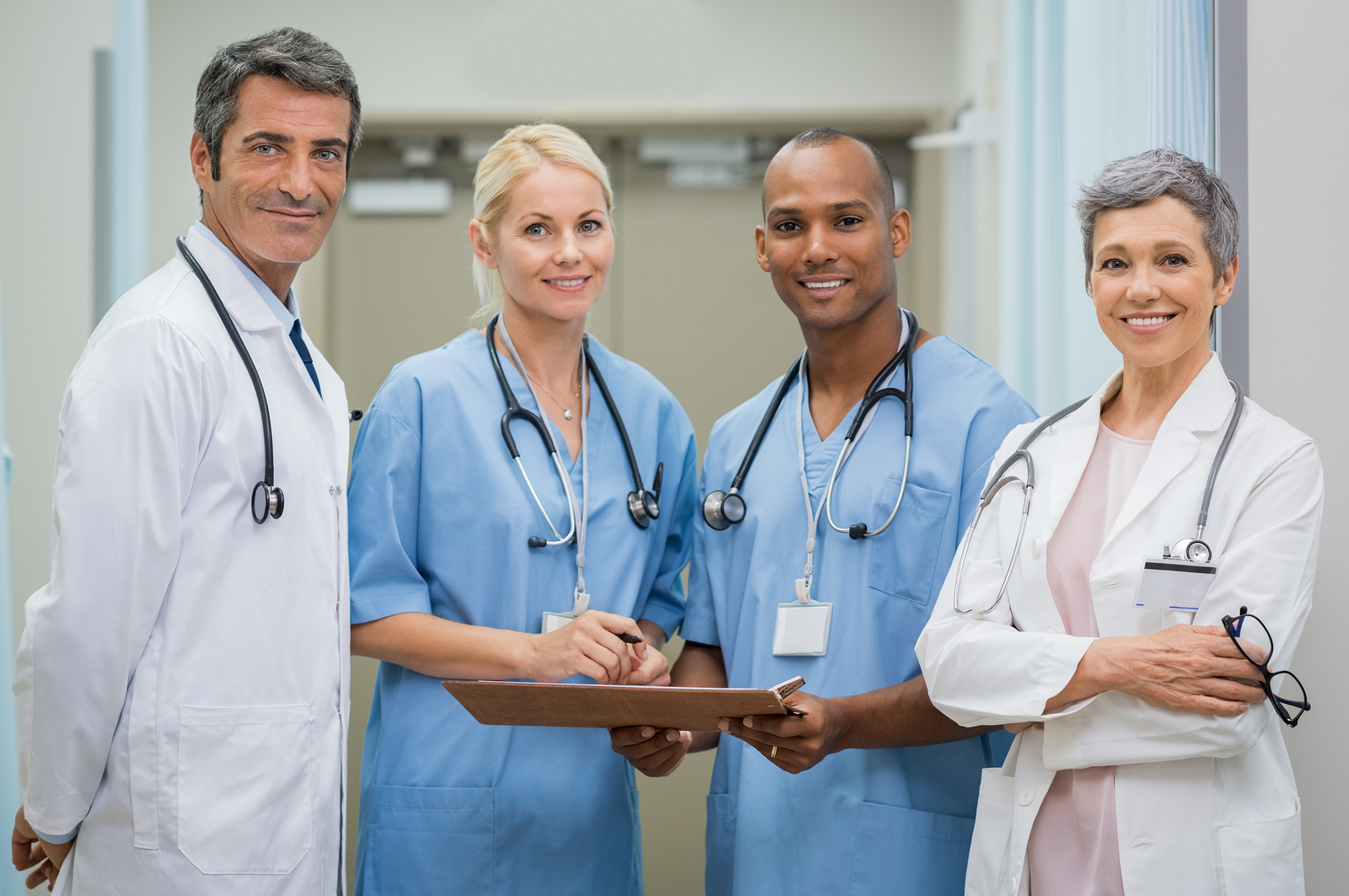 Portrait of cheerful doctors team looking at camera. 