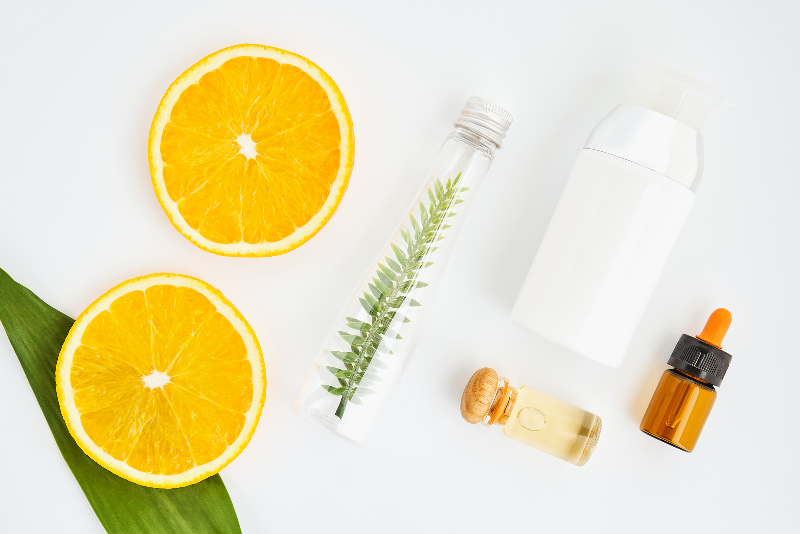 Ingredients of skin care products. And honey in the glass Blank label package for mockup on white background and flowers. The concept of natural beauty products.