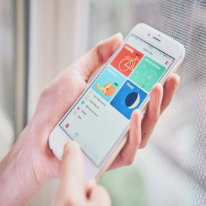 women holding smartphone on the Health app screen which monitors the fitness data of the user.