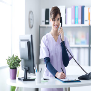 Young practitioner doctor working at the clinic reception desk