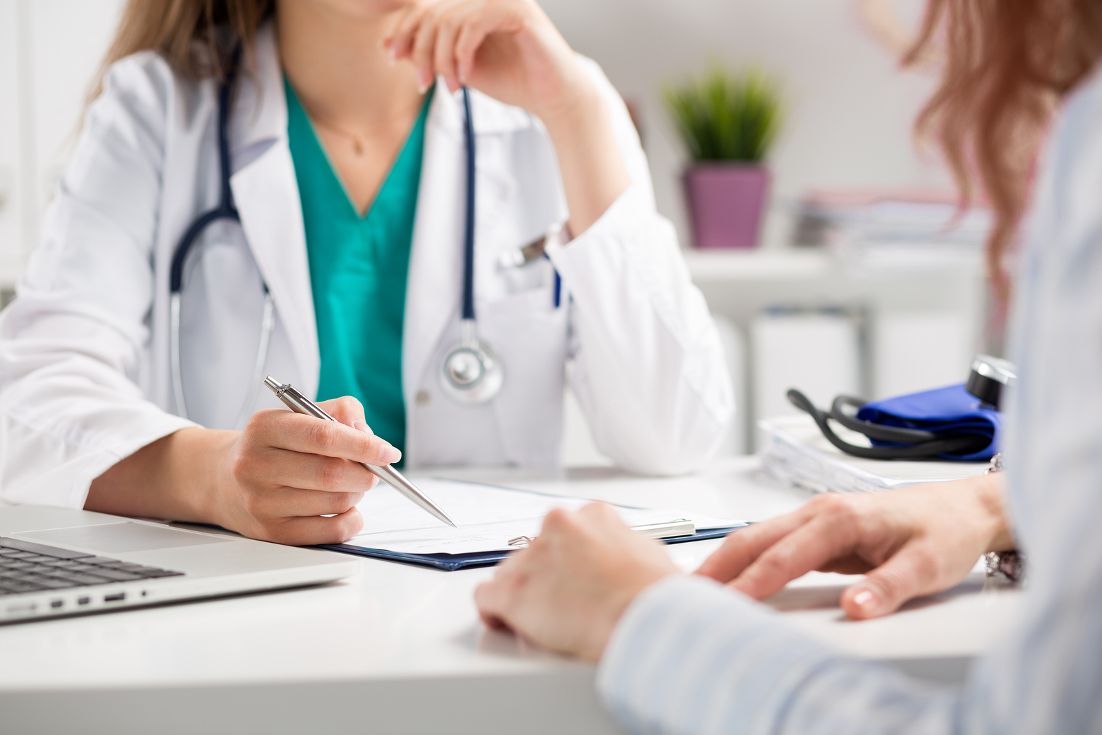 Doctor consulting patient hands closeup. Patient sitting at doctor office. Diagnostic prevention of women diseases healthcare medical service consultation or education healthy lifestyle concept